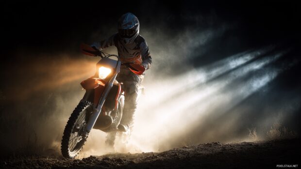 Best free HD dirt bike wallpapers featuring a thrilling night ride with bike lights illuminating the path.