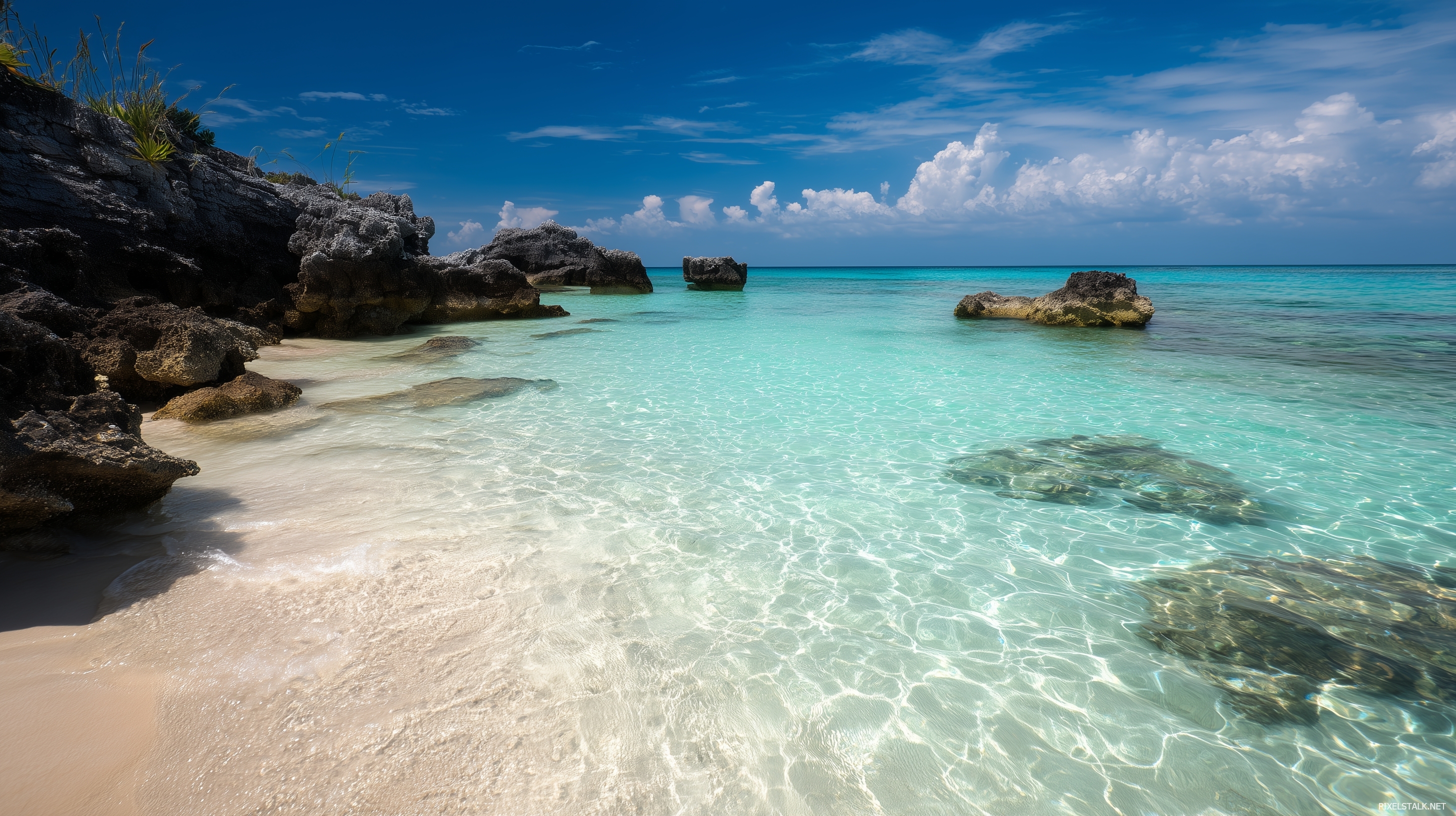 Best laptop wallpapers depicting a serene beach with crystal cle.