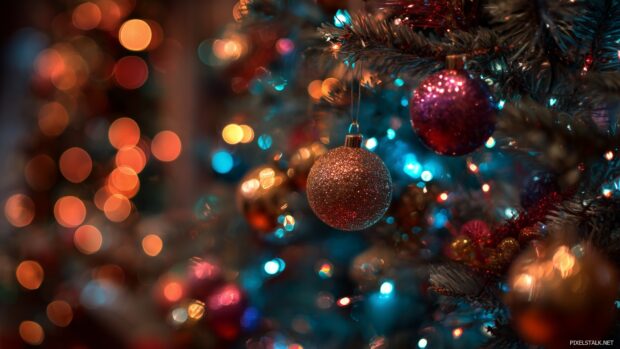 Colorful ornaments and twinkling lights on a festive tree, perfect for free xmas wallpapers download.