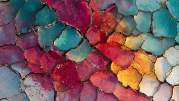 Cracked screen effect wallpaper with an artistic twist, highlighting vibrant colors and dynamic shapes.
