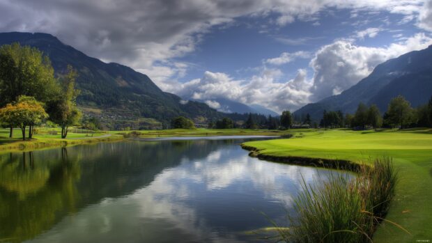 Desktop golf backgrounds, Serene scene of a golf green with a picturesque lake reflecting the sky, offering a tranquil atmosphere.