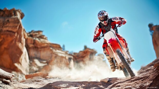 Download free HD dirt bike wallpapers emphasizing the power of a dirt bike on rocky terrain.