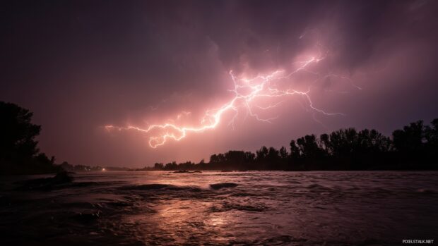 Epic stormy night scenery, An intense lightning display above a turbulent river, capturing the raw power of nature in motion.