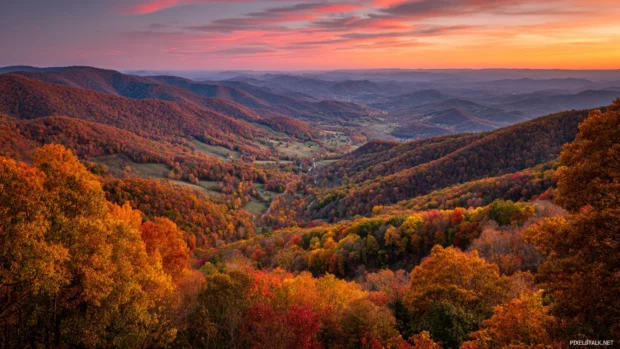 Fall colors wrapping the mountain valleys with layers of orange, red and yellow trees as the sun sets.