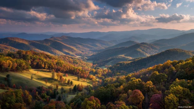 Fall mountain desktop wallpaper capturing high resolution vista of rolling hills splashed in fall colors.