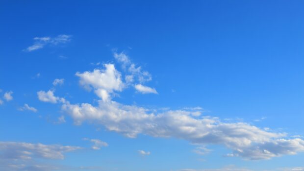 Free desktop sky backgrounds illustrating a peaceful azure sky with a scattered cloud formation.