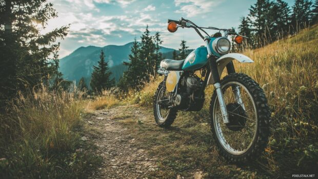 Free dirt bike wallpapers for desktop displaying a custom vintage dirt bike on a scenic trail.