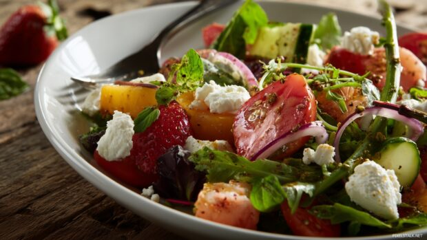 Gorgeous food images HD highlighting a farm to table salad bursting with fresh ingredients.