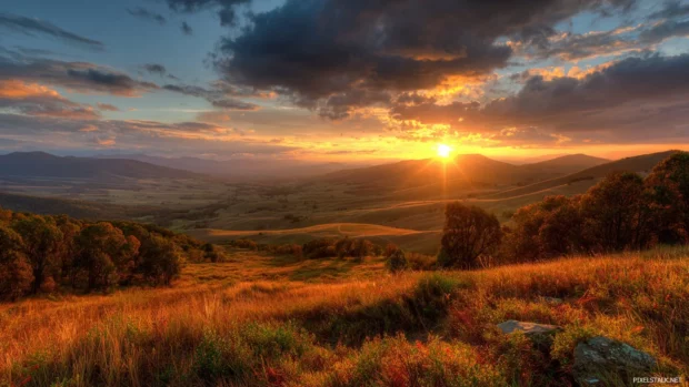 HD fall scenery wallpapers capturing the essence of a golden autumn sunset over a vast landscape.