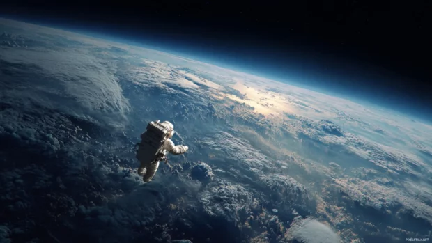 High resolution space desktop wallpaper showcasing an astronaut floating in the vastness of outer space.