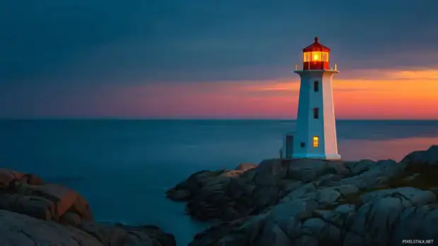 Lighthouse desktop wallpaper hd featuring beacon glowing at dusk perched on rocky cliff over calm sea.