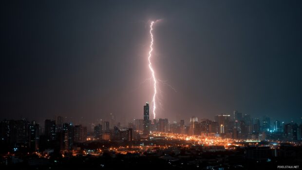 Lightning HD Wallpaper Download, A powerful lightning bolt striking a skyscraper in an urban setting at night, with city lights glowing.