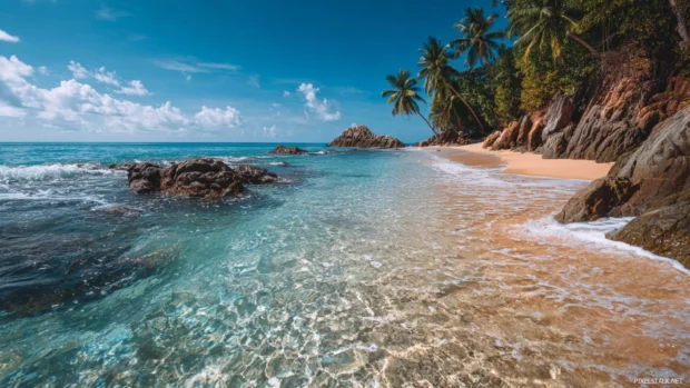 Nature beautiful backgrounds for PC displaying a peaceful beach scene with crystal clear waters and golden sand, inviting relaxation and escape.