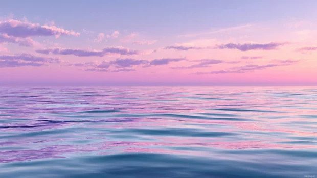 Serene ocean background hd depicting tranquil sea surface with pastel hues and subtle ripples.