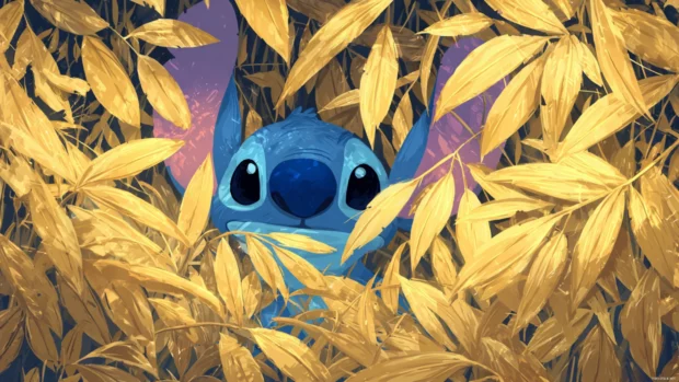 Stitch leaves wallpaper with macro view of Stitch peeking through golden leaf canopy.