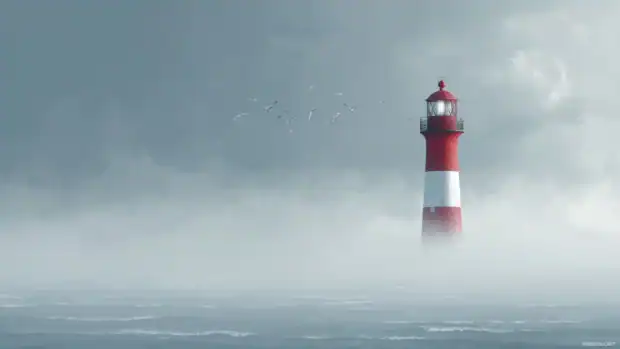 The classic red and white lighthouse shining brightly through thick ocean mist with seagulls flying overhead.