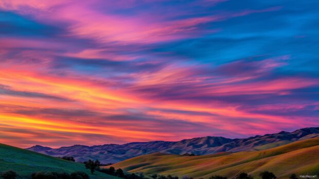 Vibrant backgrounds showcasing a lively sunset over rolling hills.