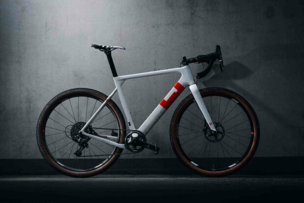 A 3T bike is standing against a concrete wall in a dimly lit room, HD Desktop Wallpaper