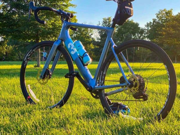 A blue 3T bike is standing on green grass under a clear blue sky, HD Desktop Wallpaper