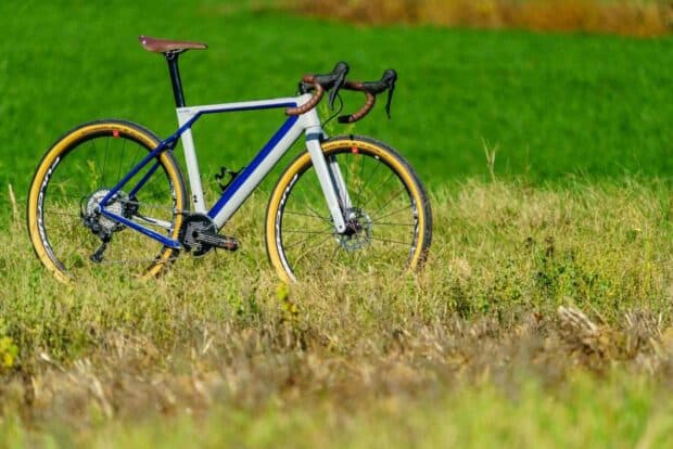 A 3T bike with yellow tires stands in a grassy field with a green background, HD Desktop Wallpaper