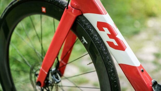 A close up view of a 3T bike frame and front wheel in a natural setting, 4K Desktop Wallpaper