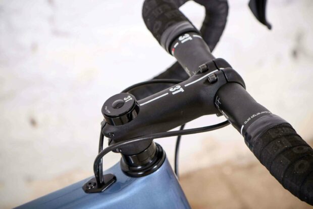 A close up view of a 3T bike handlebar with attached brake cables and wrapped grips, 2K Desktop Wallpaper