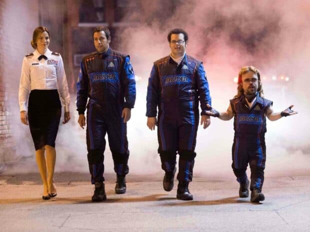 Adam Sandler and his co stars are walking through a smoky alley wearing racing suits, HD Desktop Wallpaper