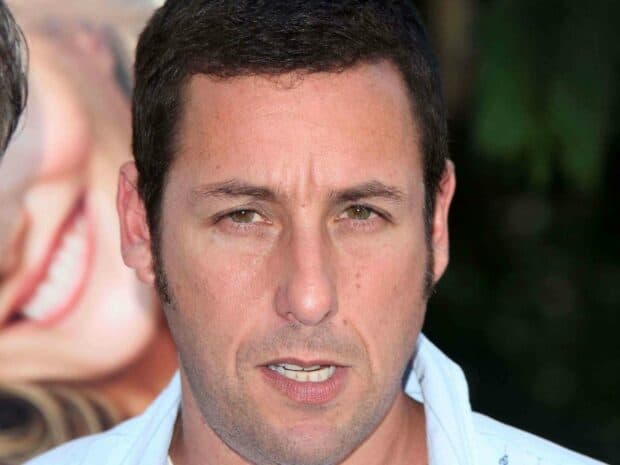 A close up portrait of Adam Sandler showing detailed facial features and expression, 2K Desktop Wallpaper