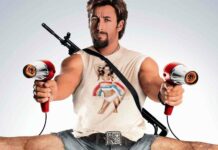 Adam Sandler holding two hair dryers with an intense expression and a weapon on his back, HD Desktop Wallpaper
