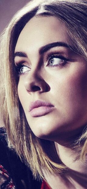 The image shows a close up of Adele looking thoughtfully to the side with clear blue eyes, HD Phone Wallpaper