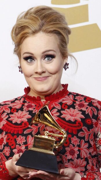 Adele proudly holding a Grammy award while wearing a red floral dress, HD Mobile Wallpaper