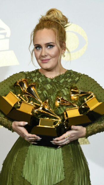 Adele is holding several Grammy awards while wearing a green dress at an award ceremony, HD Mobile Wallpaper