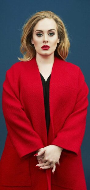 Adele wears a vibrant red coat with matching nail polish against a blue background, HD Phone Wallpaper