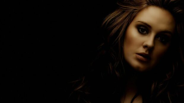 A close up portrait of Adele with dark moody lighting highlighting her facial features, HD Desktop Wallpaper