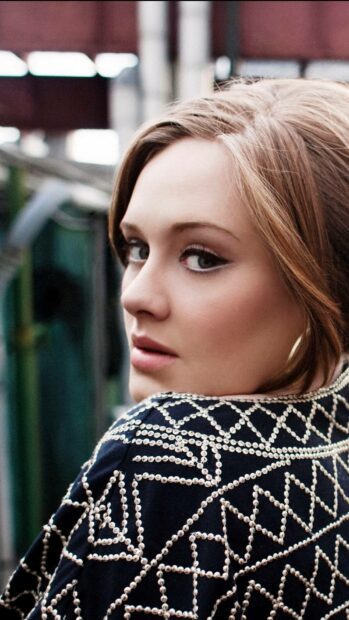 A close up of Adele wearing a detailed beaded jacket and looking over her shoulder, HD Mobile Wallpaper