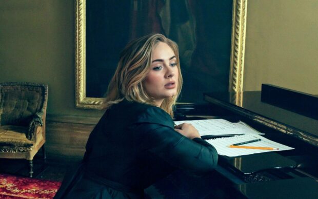 Adele is sitting thoughtfully near a piano with music sheets, HD Desktop Wallpaper
