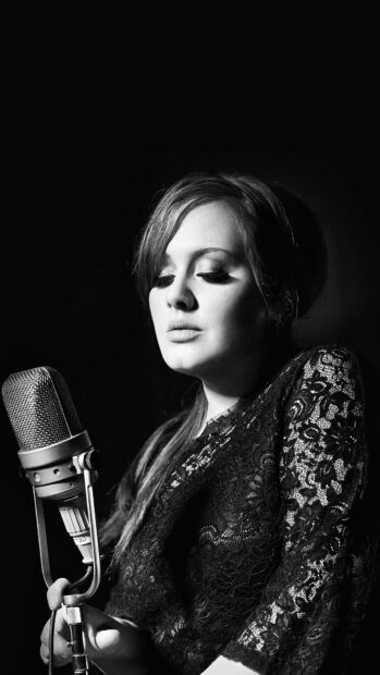 A close up of Adele singing passionately into a vintage microphone with a dark background, HD Mobile Wallpaper