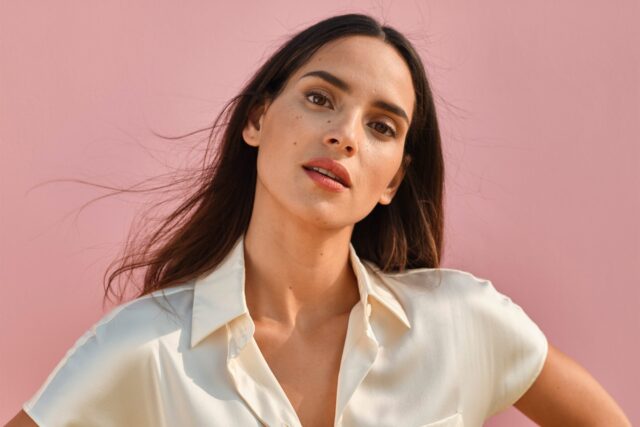 Adria Arjona Wallpapers Close Up Portrait with Pink Background and White Shirt