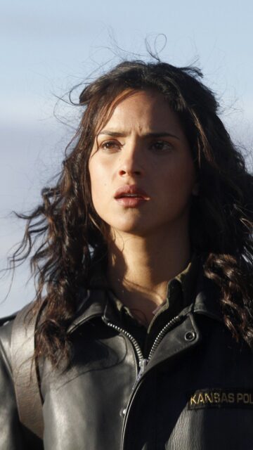 Adria Arjona portrait in Kansas Police jacket intense expression wallpaper