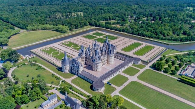 Aerial View Of Chateau De Chambord Surrounded By Gardens And Moat Wallpapers