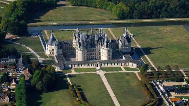 Aerial View Of Chateau De Chambord Surrounded By Green Gardens For Wallpapers