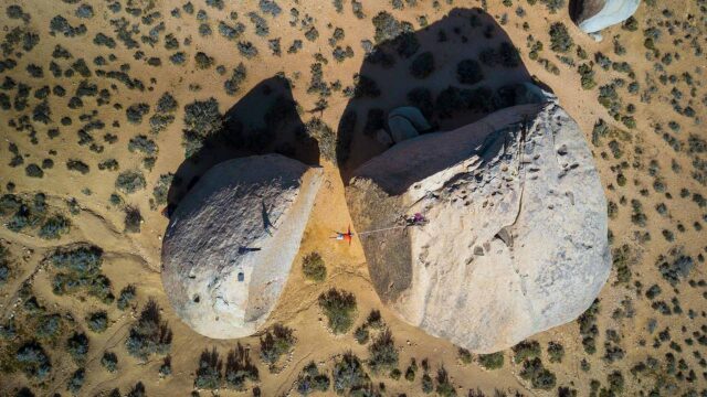 Aerial View of Person Slacklining Between Large Rocks in Desert Landscape Slacklining Wallpapers