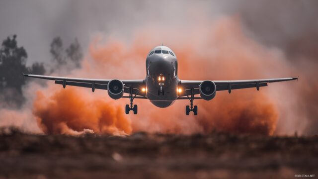 Airplane HD Background For Desktop Computer, A Dynamic View Of An Airplane Taking Off With Smoke Trailing Behind, Captured Vividly