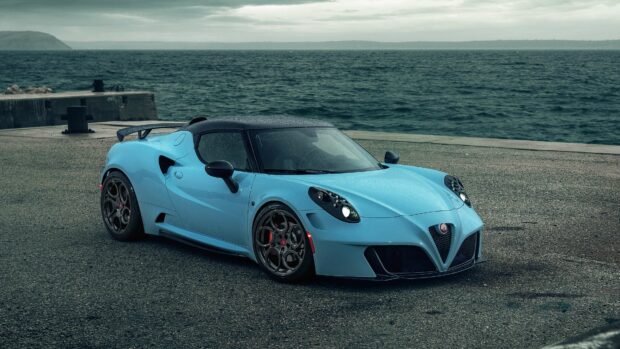 A blue Alfa Romeo is parked near an ocean pier on a cloudy day, 4K Desktop Wallpaper