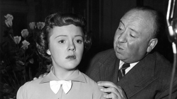 Alfred Hitchcock is seen directing a young actress during a film shoot, 2K Desktop Wallpaper