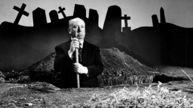 Alfred Hitchcock stands among graves holding a shovel in a dark cemetery, HD Desktop Wallpaper