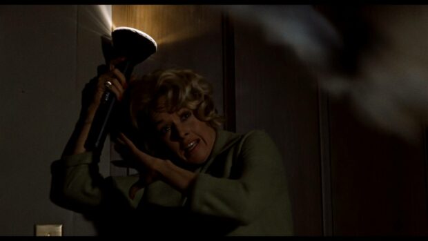 A woman holding a flashlight in a tense moment in an Alfred Hitchcock scene, HD Desktop Wallpaper