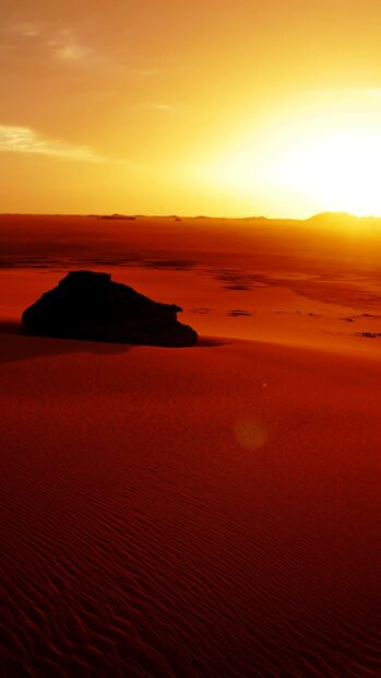 The Algeria desert displays a vivid sunset with golden light spreading over the sands, 2K Mobile Wallpaper