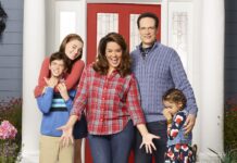 American Housewife Cast In Front Of Red Door – TV Series Wallpaper