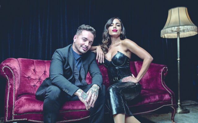 Anitta and Male Artist Sitting on Red Velvet Sofa Stylish Anitta Wallpapers
